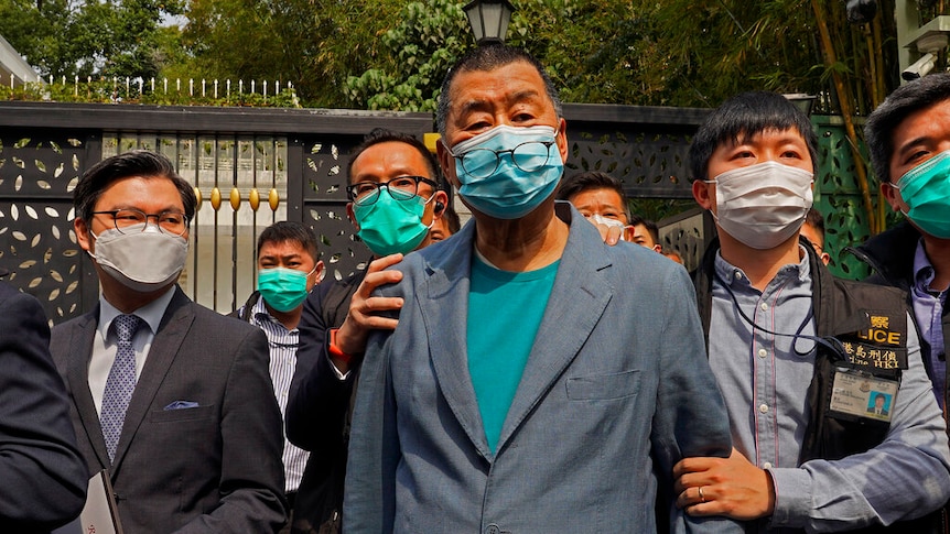 Hong Kong media tycoon Jimmy Lai is pictured being arrested by police at his home in Hong Kong.