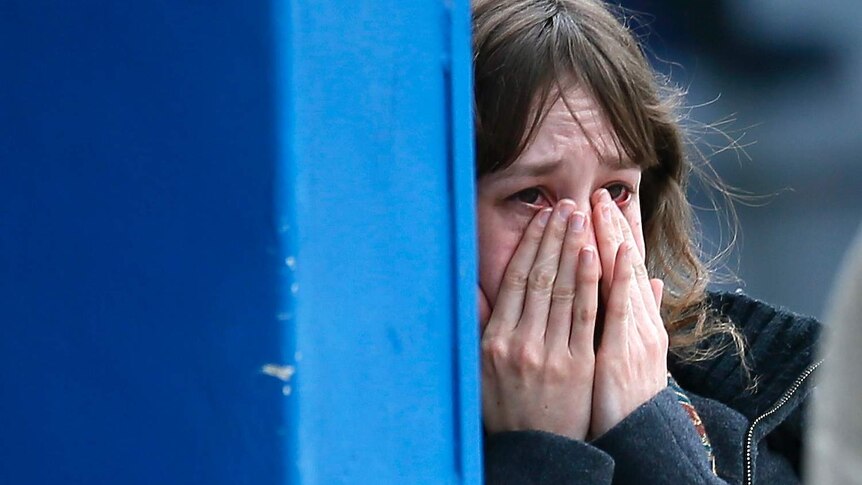 Woman cries over relatives killed in Germanwings crash