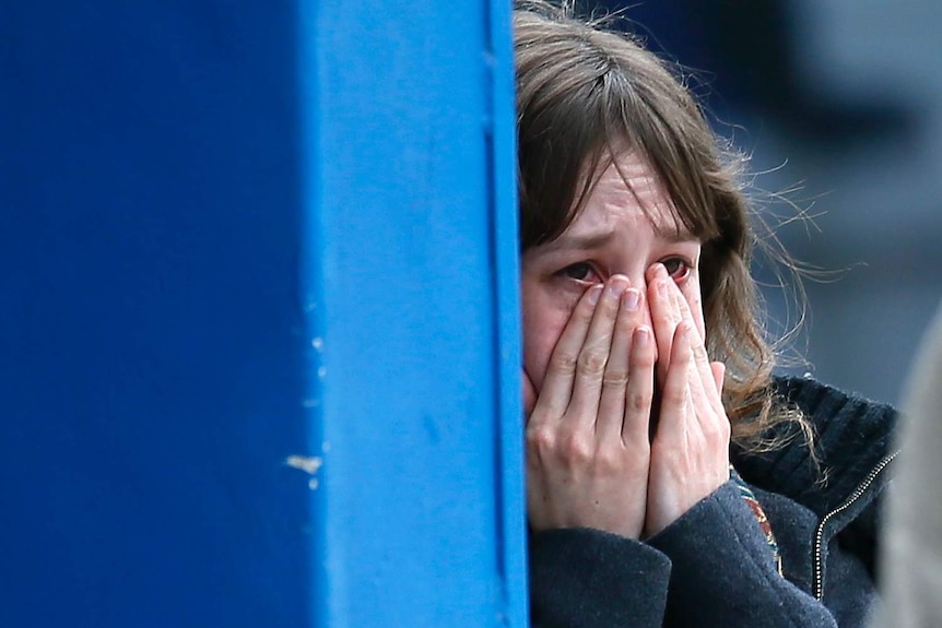 Woman cries over relatives killed in Germanwings crash