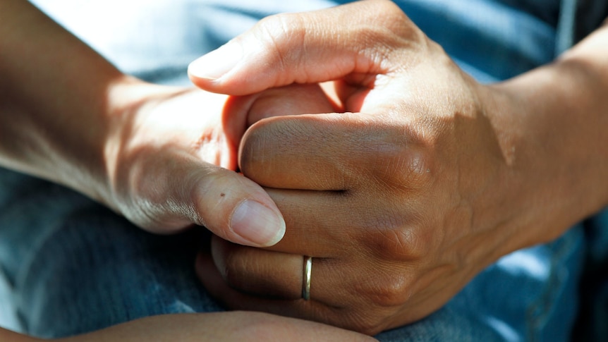 Hands being held in support