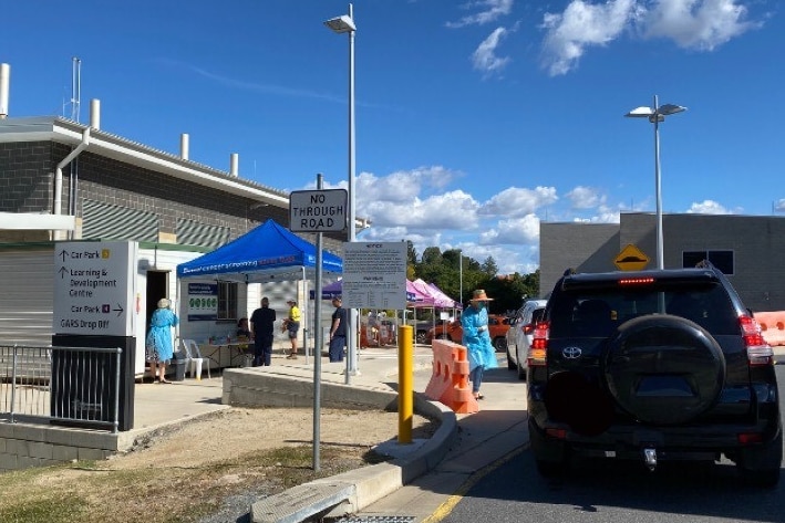 Photo of cars lined up outside health facility