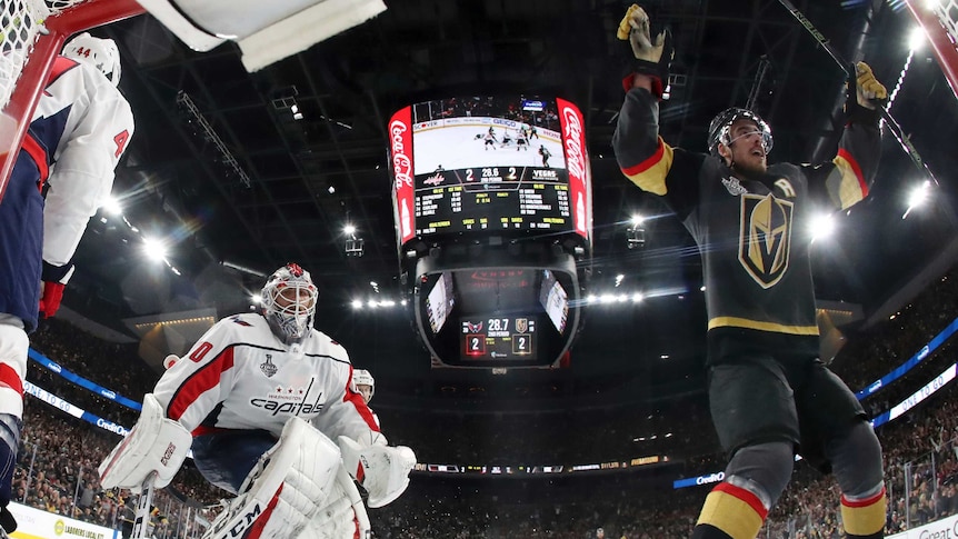 The goalkeeper watches on from the left of the picture as the Vegas Golden Knights player Reilly Smith skates off, arms aloft
