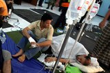Survivors of a boat sinking off Indonesia en route to Australia are treated at a temporary shelter.