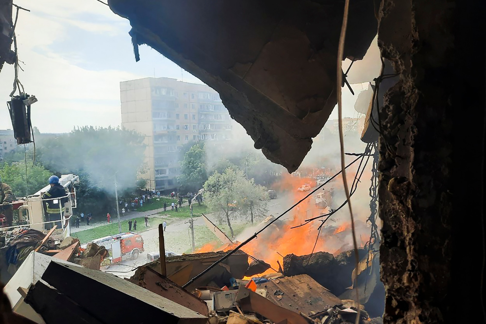 The view looking outside from inside an apartment building damaged by an explosion. 