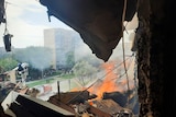 The view looking outside from inside an apartment building damaged by an explosion. 