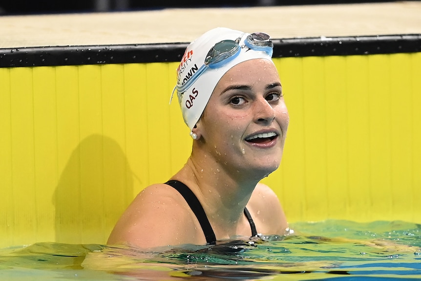 Swimmer smiles after finishing a race. 