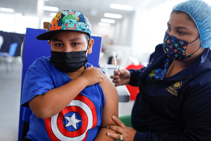 A young boy receives a vaccine. 