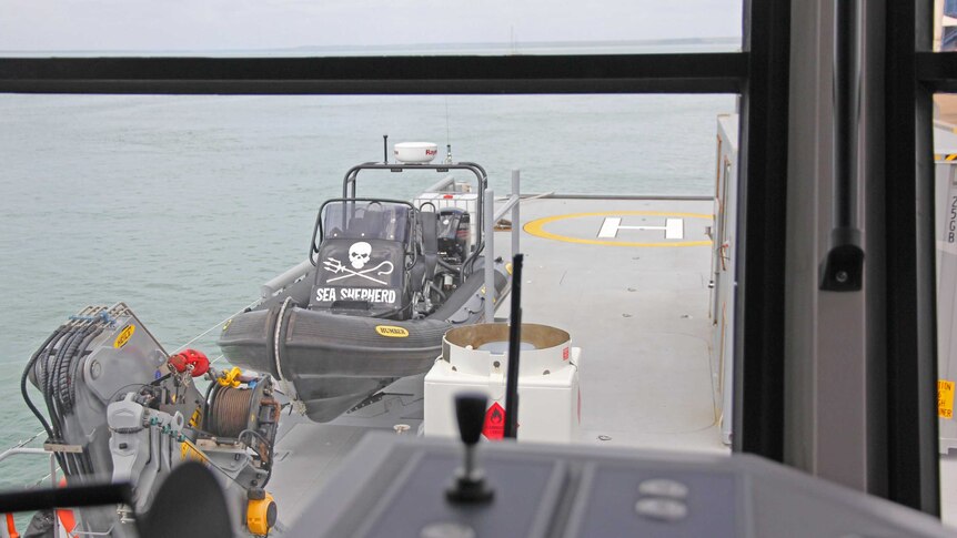 A smaller Sea Shepherd vessel docks on the deck of the Ocean Warrior ship.