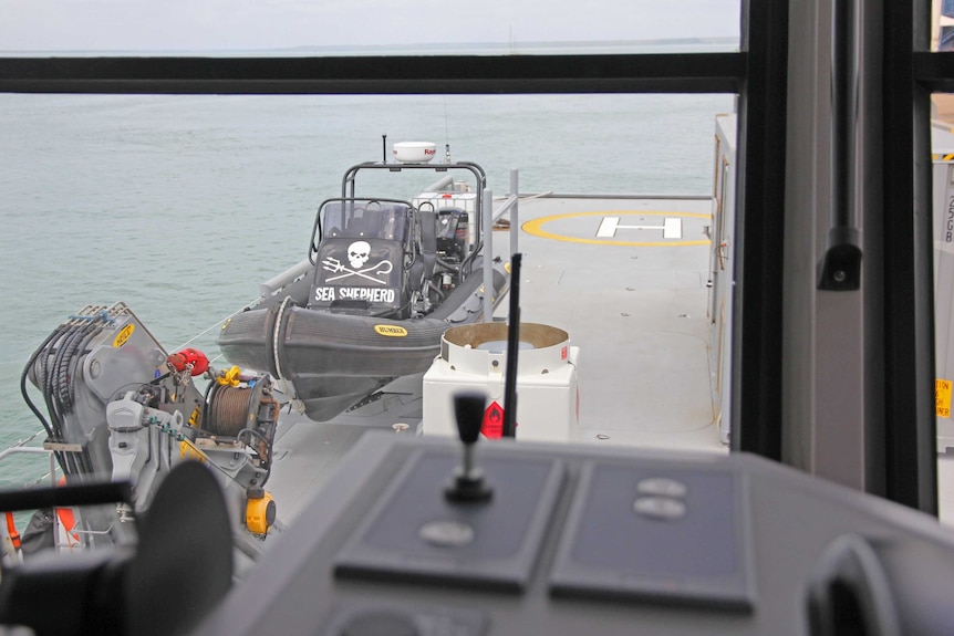 A smaller Sea Shepherd vessel docks on the deck of the Ocean Warrior ship.