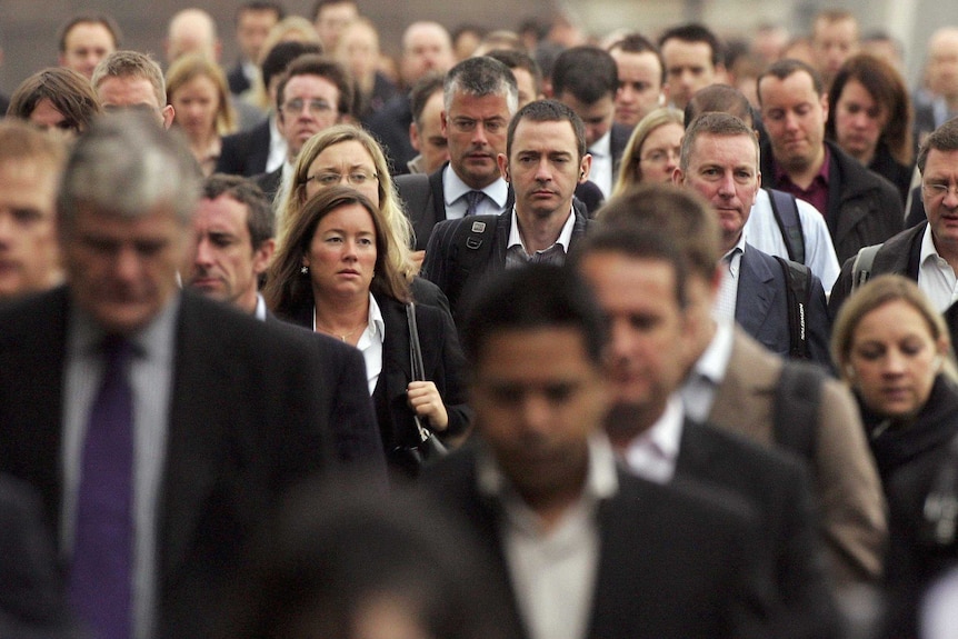 Commuters walk to work over London Bridge