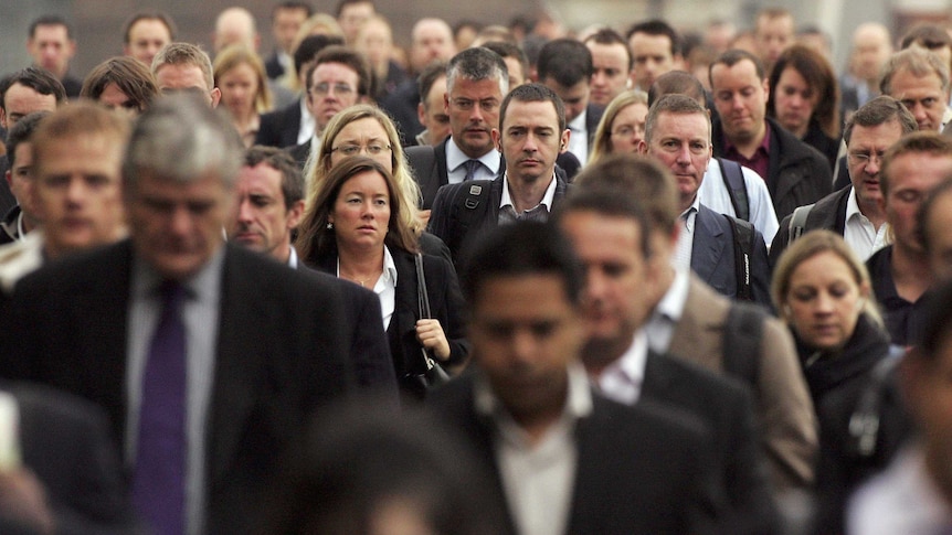 Commuters walk to work over London Bridge