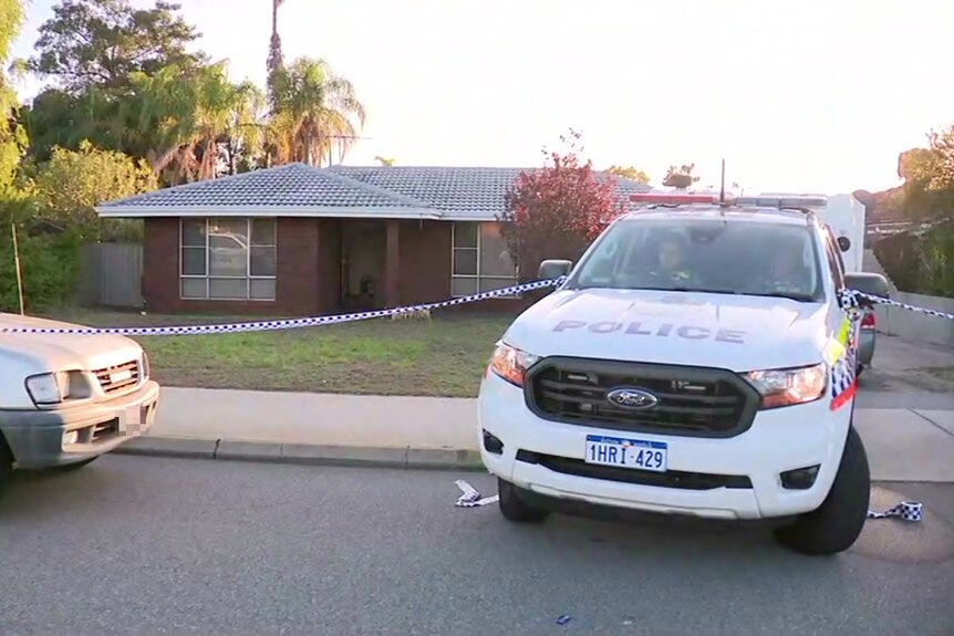 A police ute and the front of a silver car pictured outside a suburban house, with police tape cordoning off the property.