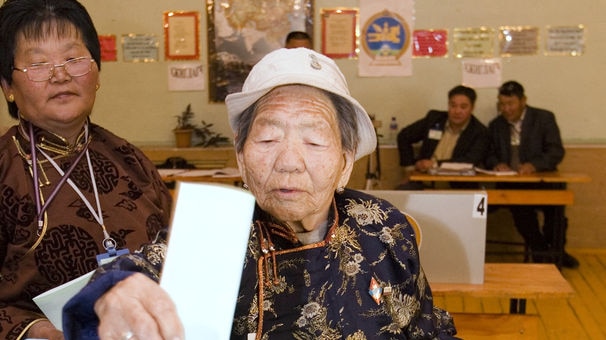 Elderly Mongolian woman casts her vote