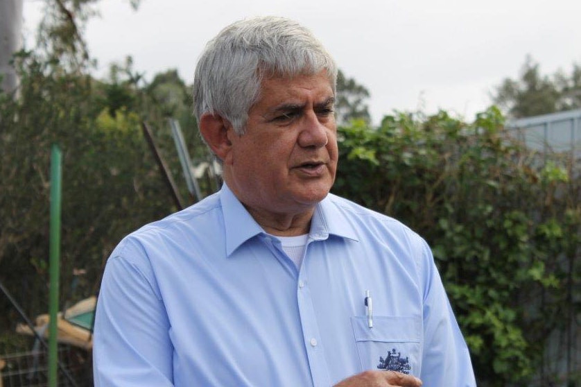 Member for Hasluck, Ken Wyatt wearing a blue shirt in a suburban backyard.