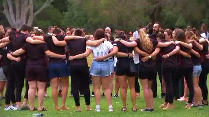 Attendees form a circle before the vigil gets underway