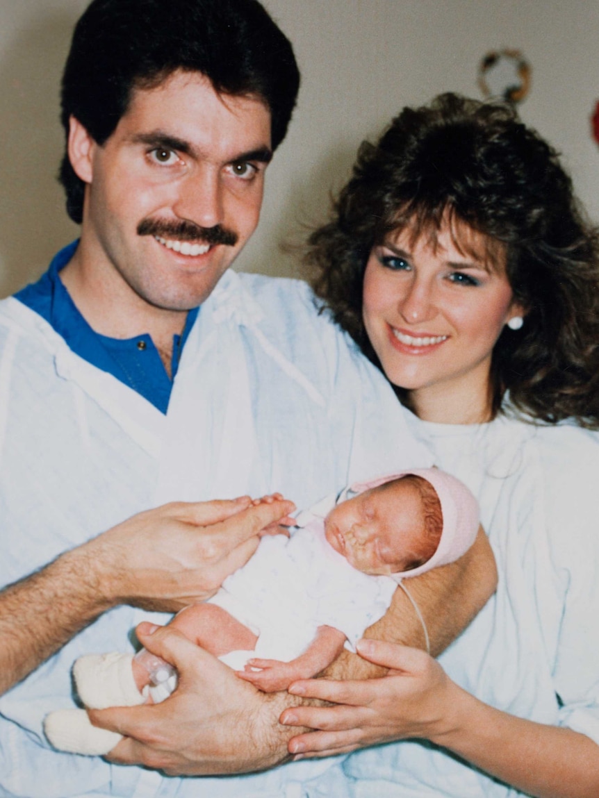 Rachelle Mainse as a newborn being held by her parents