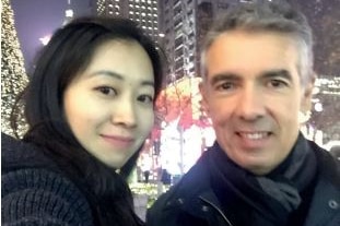 Angelo Tsirekas with a woman wearing warm clothing in a Chinese city