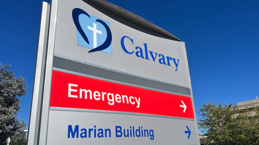 A sign that says Calvary Hospital on a sunny day. 