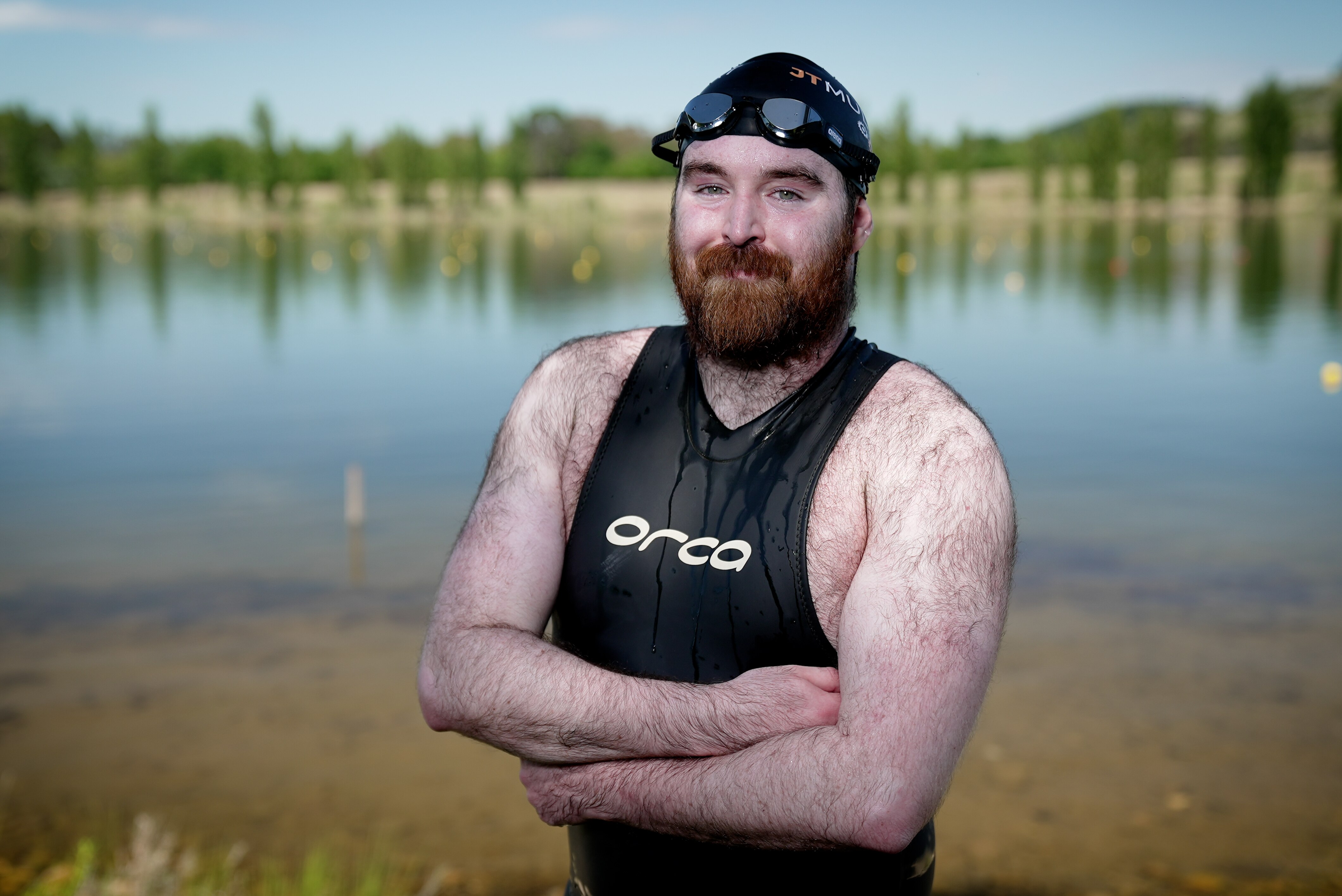 a man in a wetsuit in shallow water in lake burley griffin