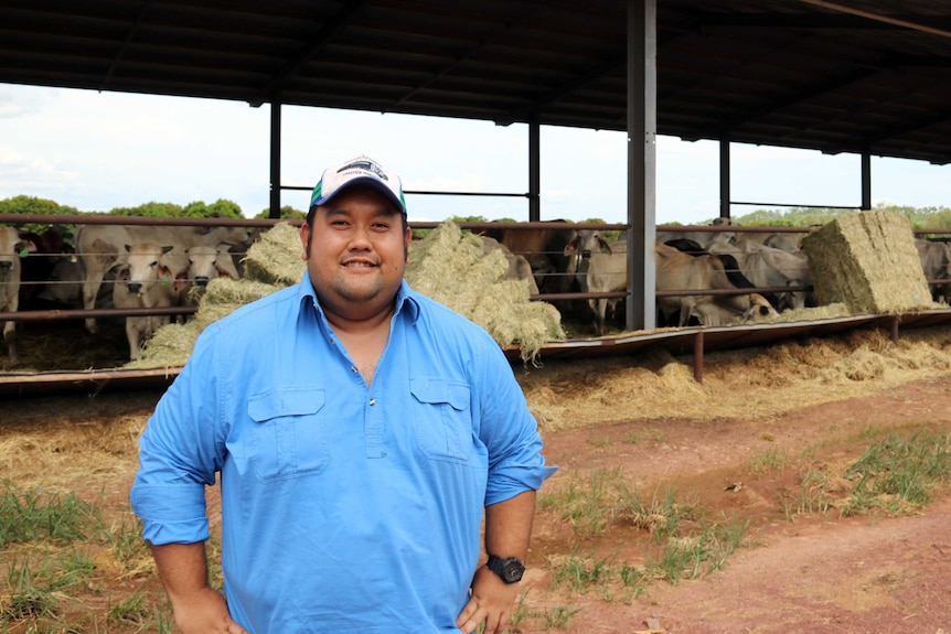Indonesian cattle buyer Iqbal Siregar standing in front of cattle export yards outside of Darwin