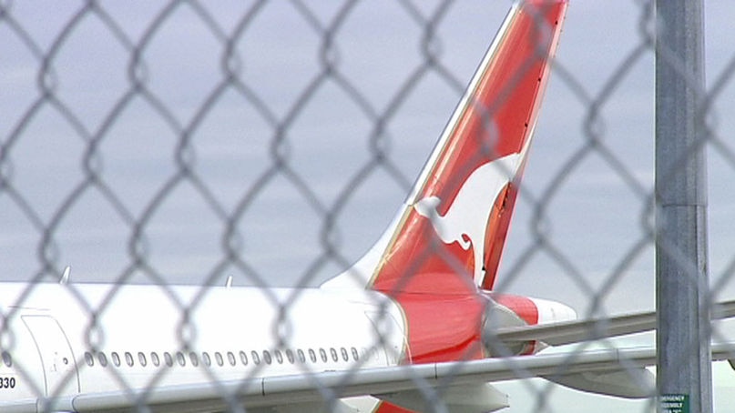 shot of plane behind wire fence