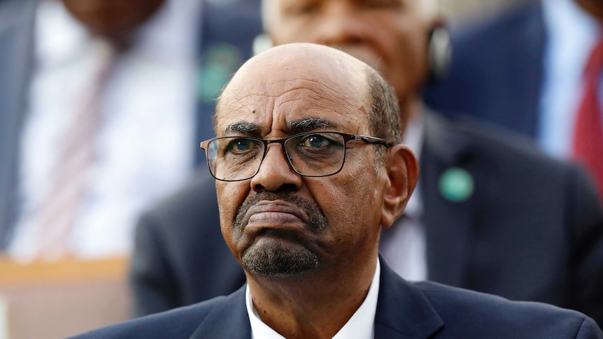 Sudan's President Omar al-Bashir looks straight ahead wearing a suit and tie.