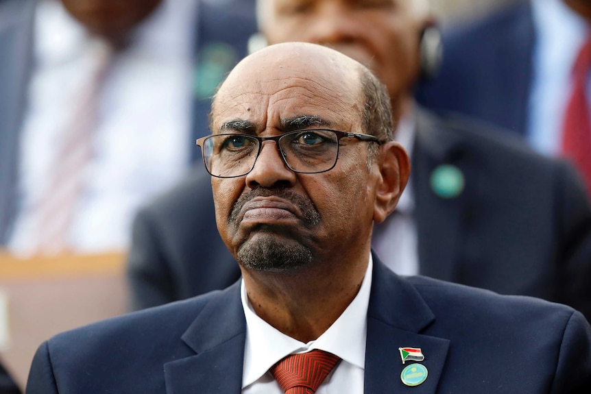 Sudan's President Omar al-Bashir looks straight ahead wearing a suit and tie.