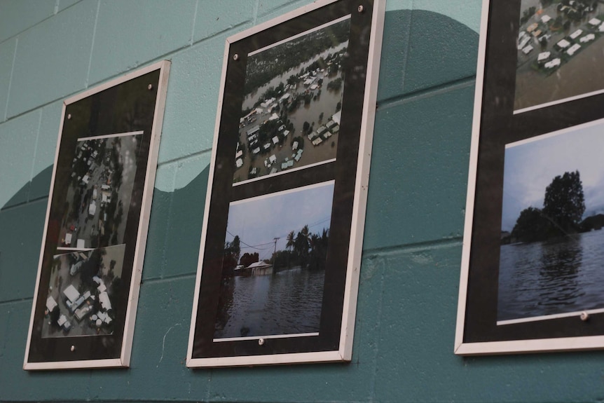 A wall of photographs of floods