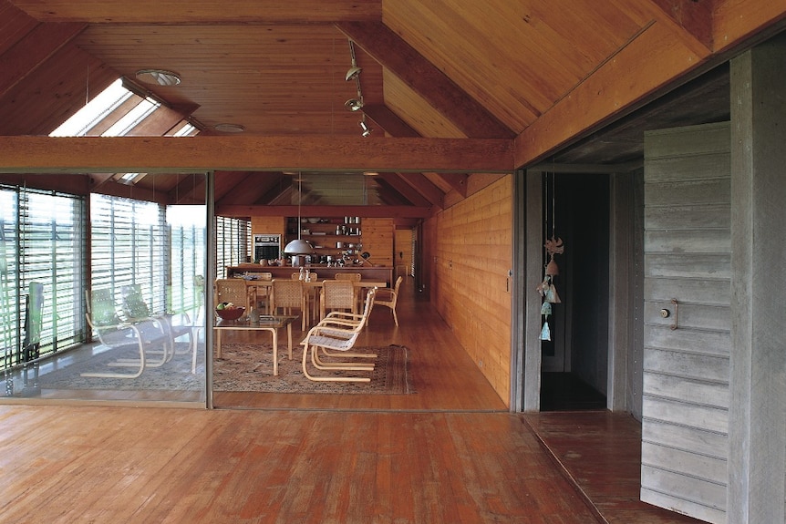 Wood-panelled interior of the living room of a house.