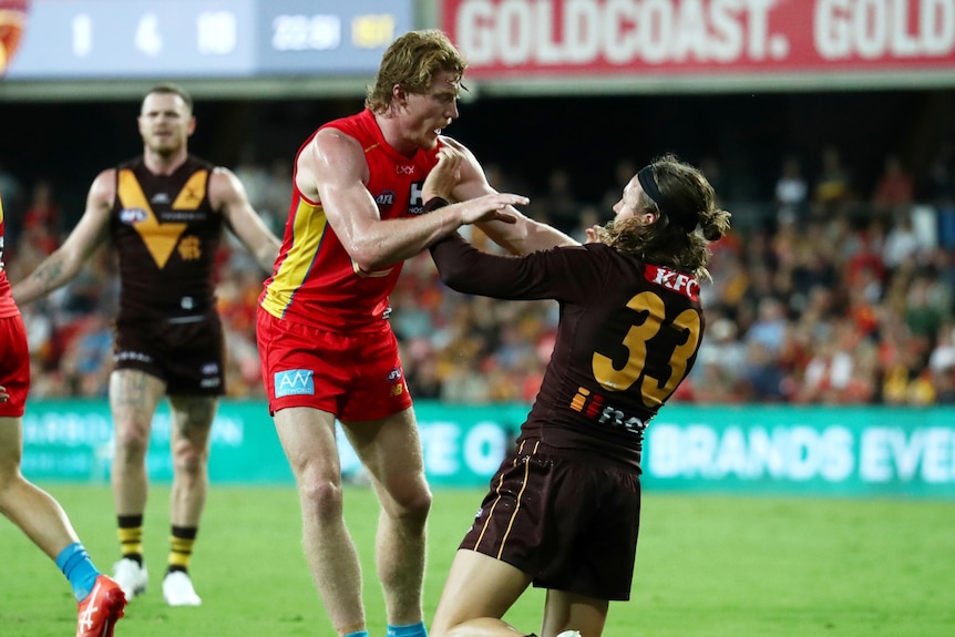 Matt Rowell pointing to opponent Jack Ginnivan of the Hawks, who is on his knees attempting to get up