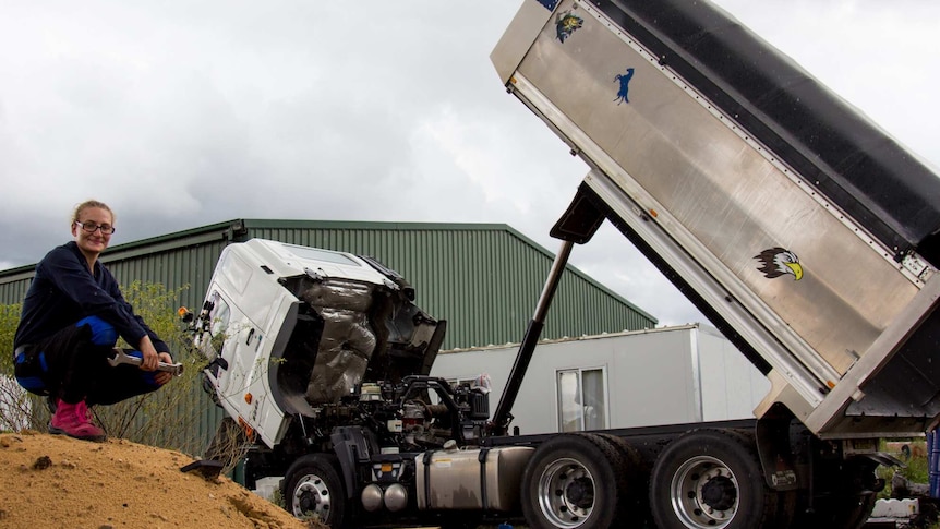 Louise Azzopardi kneeling with truck