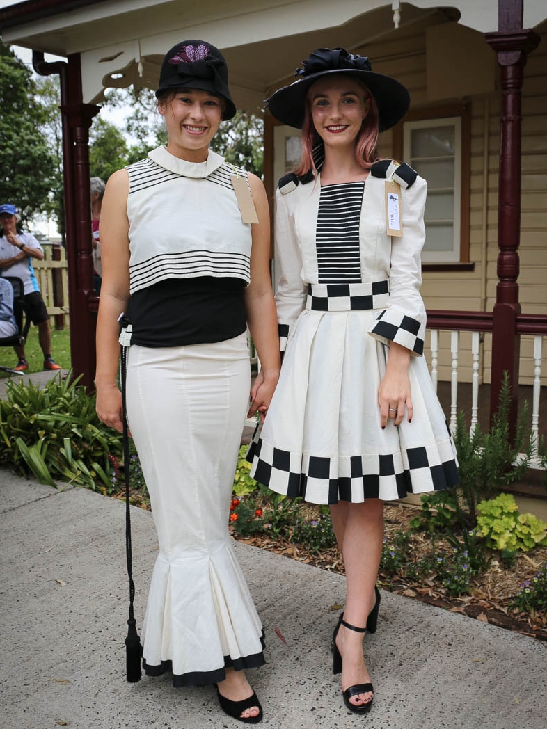 Models in old-fashioned black and white outfits