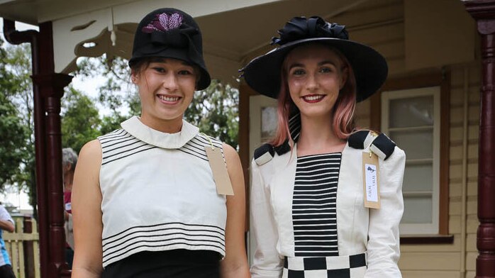 Models in old-fashioned black and white outfits