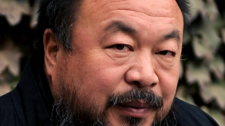 Chinese artist Ai Weiwei sits in the courtyard of his home in Beijing