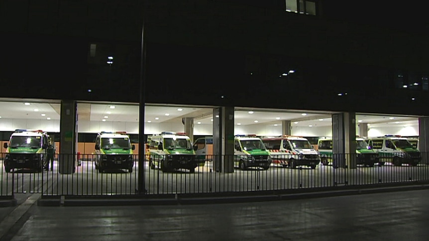 A row of ambulances parked in a hospital carpark
