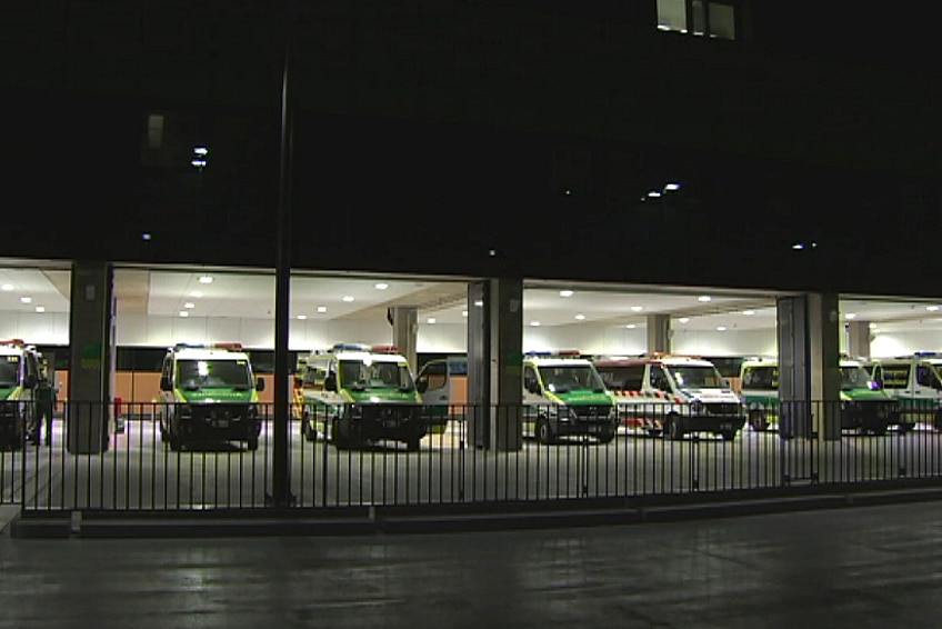 A row of ambulances parked in a hospital carpark