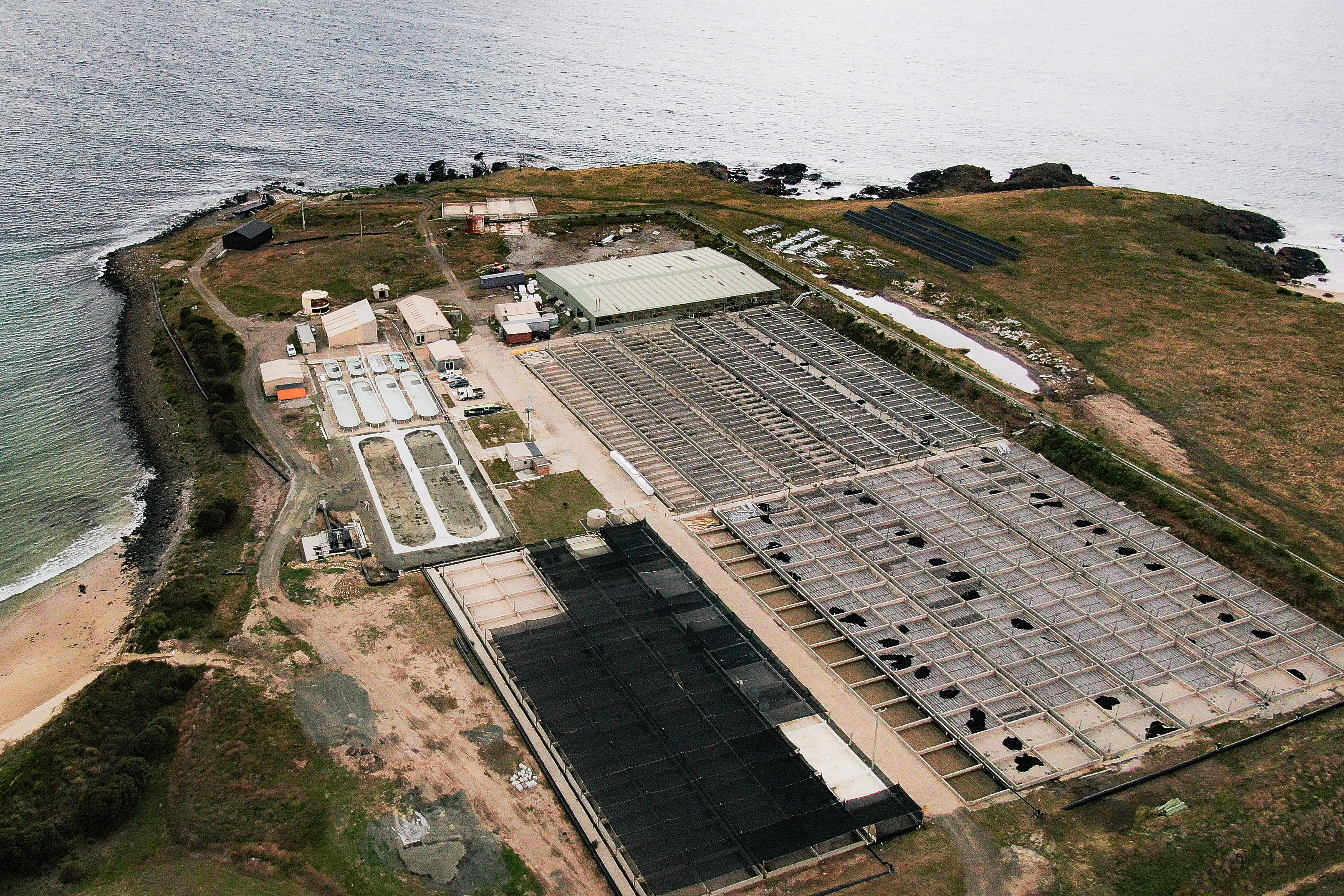 Water, green terrain and a factory