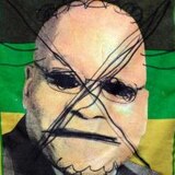 A photo of Former President Jacob Zuma on the South African flag has been crossed out and horns drawn on his head.