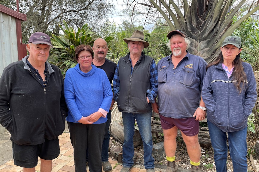 A group of six men and women standing side by side.