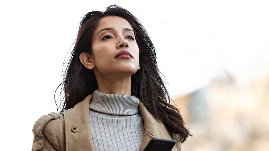 Woman with long dark hair staring confidently into the distance in a story about family cultural identity.