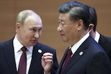Russian President Vladimir Putin, left, gestures while speaking to Chinese President Xi Jinping 