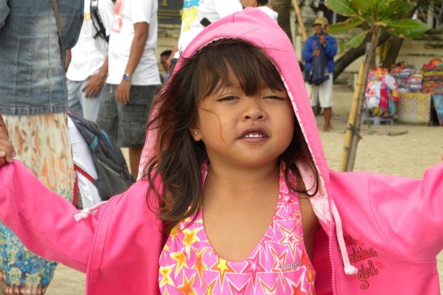 Small Indonesian child wearing bright pink