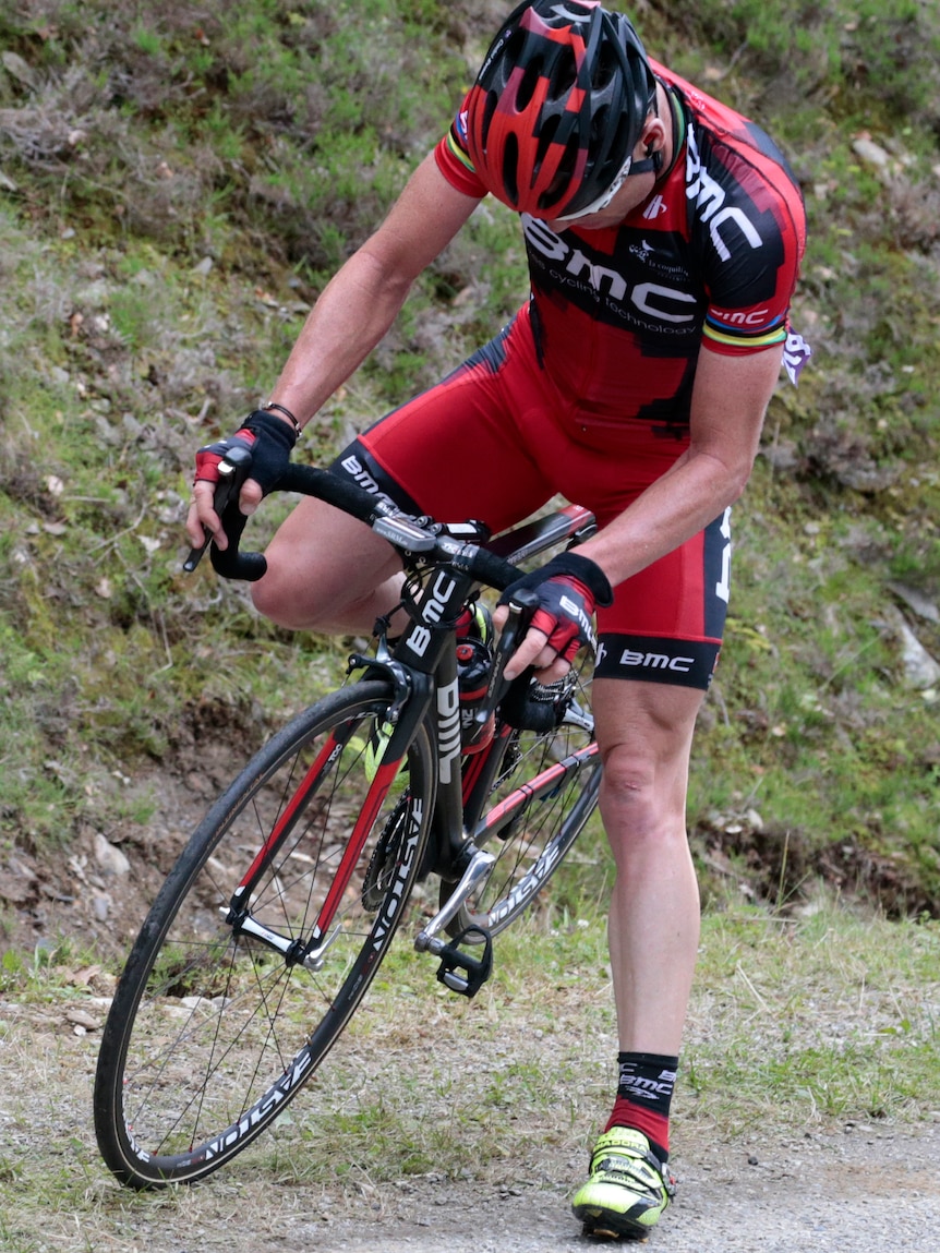 Tour de France 2011 winner, Australia's Cadel Evans starts riding after he had a flat tyre.