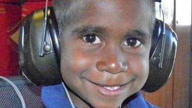 An Indigenous boy has his hearing tested