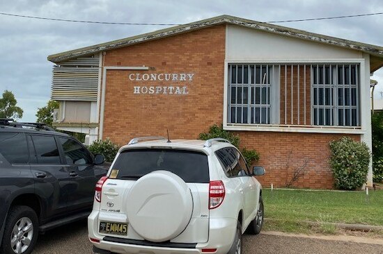 A plain red brick hospital building in an outback town