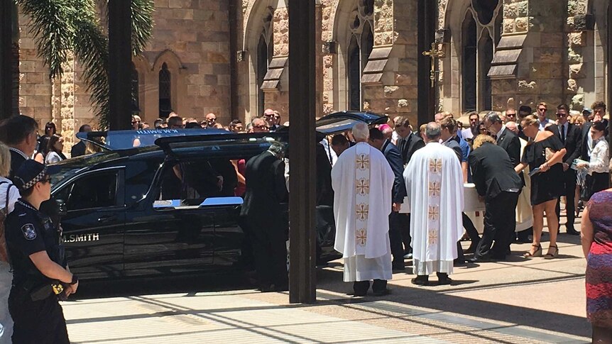Cole Miller's coffin is loaded into a funeral car.