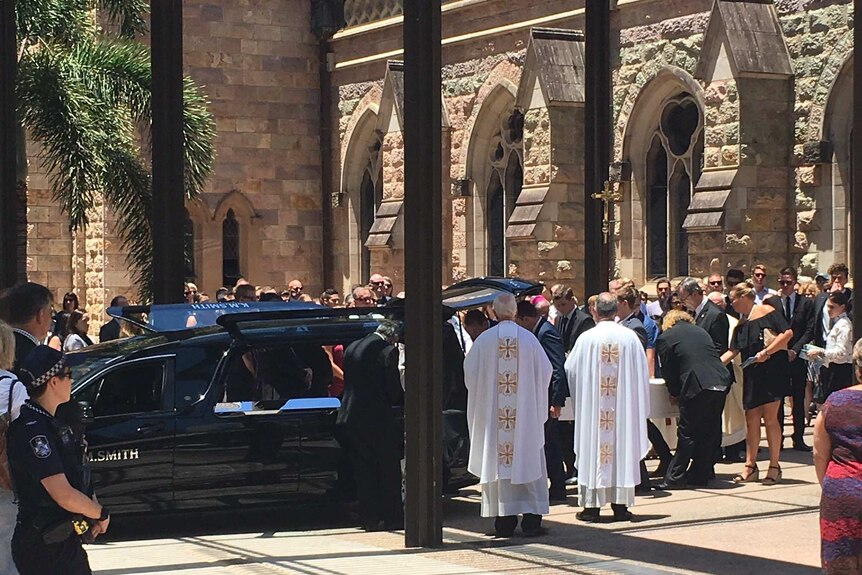 Cole Miller's coffin is loaded into a funeral car.