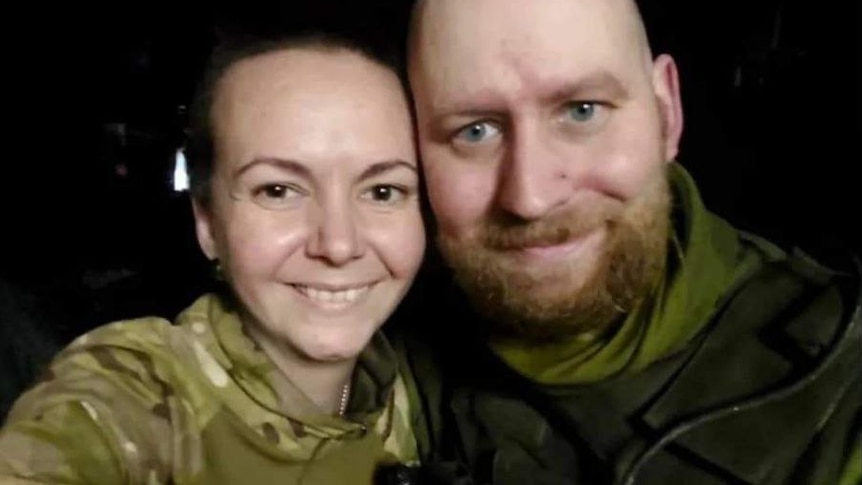 Two smiling Ukrainian soldiers. 