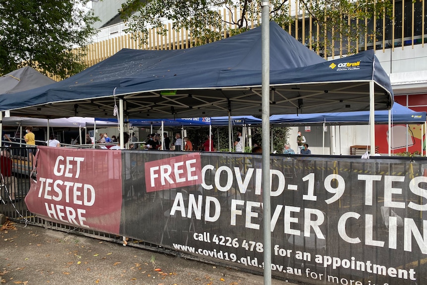A covid testing marquee covered in covid signage 