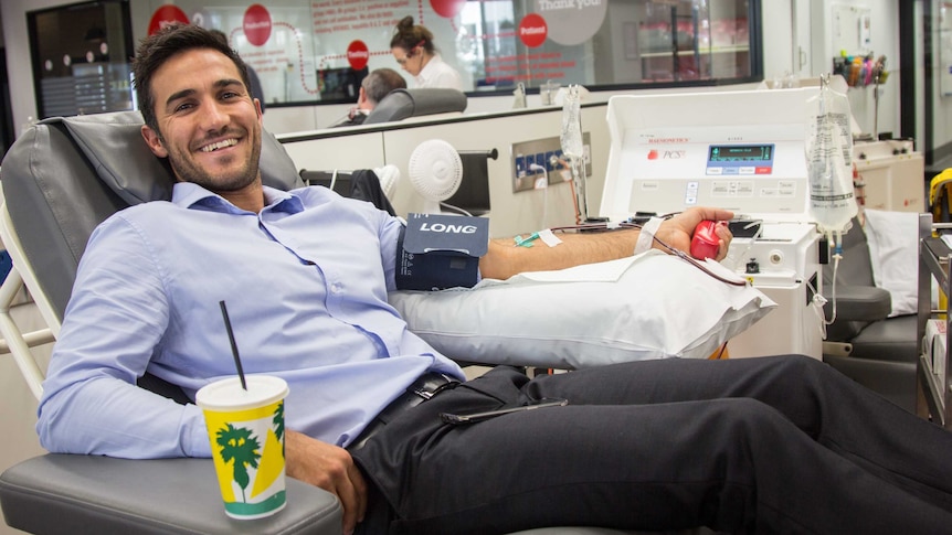 Justin Mansillas gives blood at the  Perth Blood Donor Centre.
